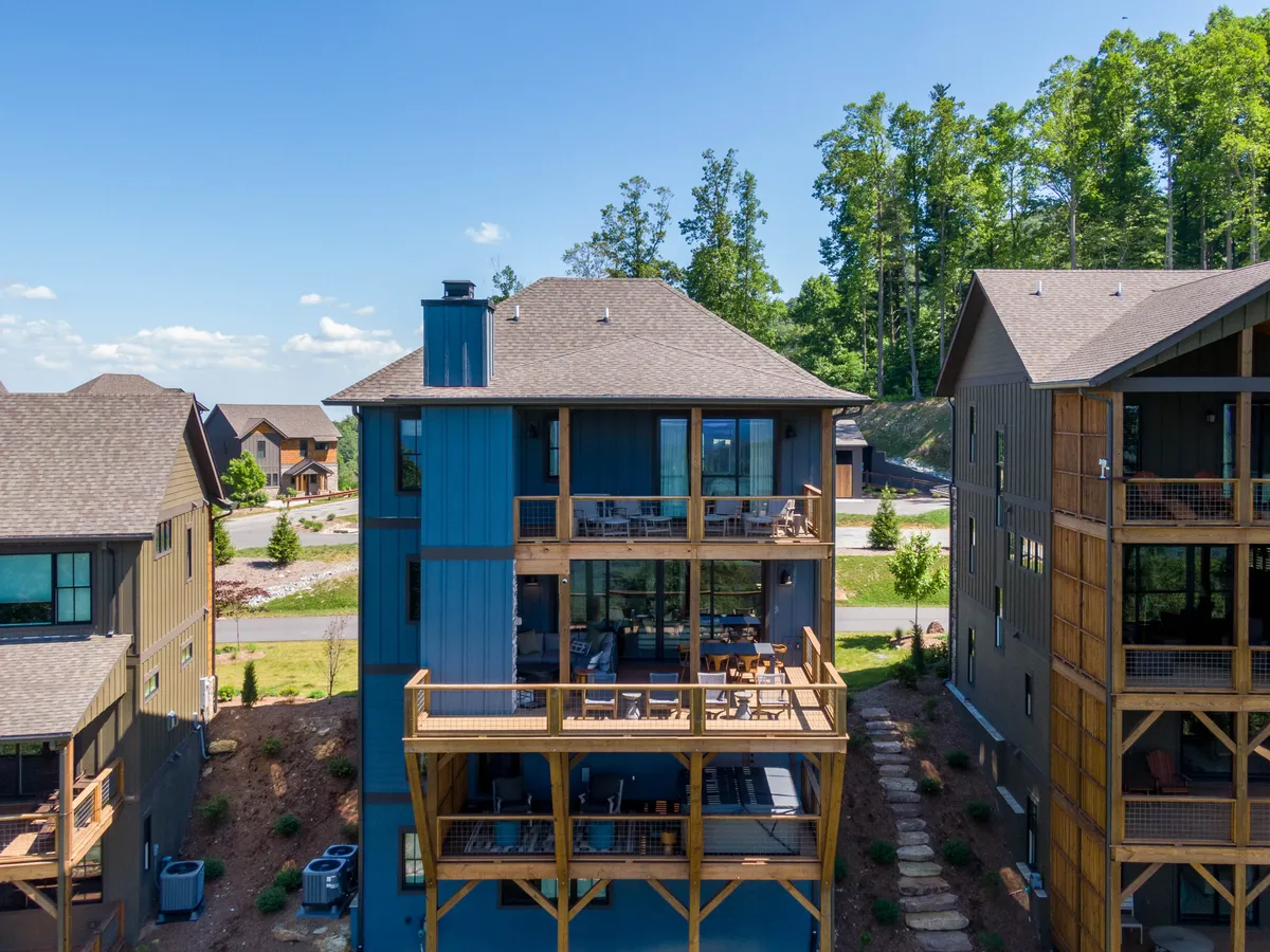 Modern architecture with spacious balconies overlooking well-maintained pathways and lush natural surroundings. The expansive outdoor spaces create a seamless connection between home and wilderness, inviting residents to step out and explore.